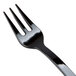 A close up of a Fineline black plastic tasting fork with a white background.