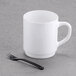 A white mug with a black Fineline Tiny Tines fork inside.