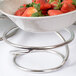 An American Metalcraft stainless steel riser with a bowl of strawberries on a table.