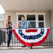 A couple of women on a porch with a Valley Forge United States of America flag.