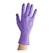 A hand wearing a purple Kimtech nitrile glove.