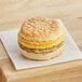 A Grand Prairie Sausage, Egg, and Cheese Biscuit sandwich on a napkin.