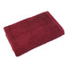 A red 1888 Mills Millennium bath towel.