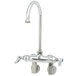 A T&S chrome wall mount faucet with 2 handles and a swivel gooseneck.