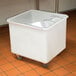 A white Cambro ingredient storage bin with a sliding lid sits on a counter.