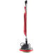 An Oreck floor polisher with a red cord and black handle.