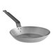 A Choice carbon steel frying pan with a handle.