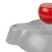 A gray plastic object with a red button on top.
