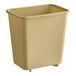 A beige plastic Lavex wastebasket.