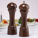 Two Chef Specialties Windsor Walnut salt and pepper shakers on a table.
