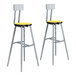 Two National Public Seating Titan lab stools with yellow and gray seats and backrests.