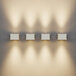 Four Ape Labs Sconce 2.0 wall lights on a white wall with a black border.