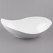 A white porcelain canoe bowl with a curved edge.