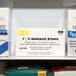 A shelf with several white boxes of Medique adhesive bandage strips.