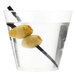 A clear Fineline plastic tumbler filled with a liquid and olives with a stick in it.