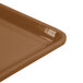 A close-up of a brown Cambro dietary tray with a plastic handle.
