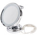 A round silver Conair lighted wall-mount mirror with a cord. 