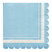 A blue napkin with a white scalloped edge.