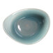 A RAK Porcelain deep organic bowl with a white circle on a blue surface.