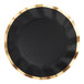 A close up of a black wavy Sophistiplate paper dinner plate with gold accents.
