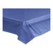 A navy blue plastic tablecloth unrolled on a table.