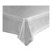 A metallic silver plastic table cover roll on a white tablecloth.