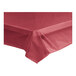 A burgundy plastic table cover roll on a table.