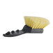 A close-up of a black and white Carlisle Sparta utility brush with yellow bristles and a black handle.