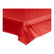 A red plastic table cover roll on a table.
