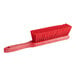 A red Carlisle Sparta counter brush with a red handle.