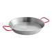 A close-up of a silver Matfer Bourgeat carbon steel paella pan with red handles.