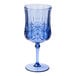 A Sophistiplate cobalt blue wine glass with a design on it.