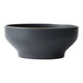 A close up of a black bowl with a white border.