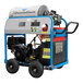 A Delco Streamliner portable hot water pressure washer with wheels, a black and blue frame, and a hose.