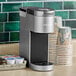 A Keurig K-Suite single serve coffee maker on a kitchen counter.