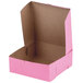 A pink bakery box with a lid open.