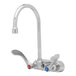 A silver T&S wall-mounted workboard faucet with gooseneck spout and wrist action handles.