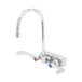 A T&S chrome wall-mounted workboard faucet with gooseneck spout and wrist action handles.