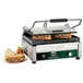 A Waring Panini Supremo sandwich grill with sandwiches cooking on it.