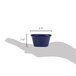 A hand holding a navy blue smooth melamine ramekin with measurements.
