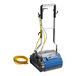 A white and blue NaceCare Solutions Duplex walk behind floor scrubber with a yellow cord.