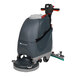 A NaceCare Solutions cordless walk behind floor scrubber with a green and black machine, wheels, and a handle.