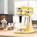 A KitchenAid Majestic Yellow stand mixer on a counter.