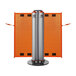 A close-up of a silver metal ZonePro dual rolling stanchion with orange safety banners.