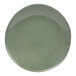 A moss green porcelain bowl with a white rim.