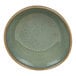 A close-up of a moss green Front of the House Artefact ramekin with a brown rim.