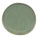A close-up of a Front of the House Artefact moss green porcelain plate with a brown rim.