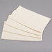 A stack of folded Hoffmaster ecru paper dinner napkins.