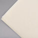 A close-up of a Hoffmaster ecru/ivory paper dinner napkin.