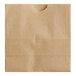 A close-up of a natural brown Bagcraft paper bag with a hole in it.